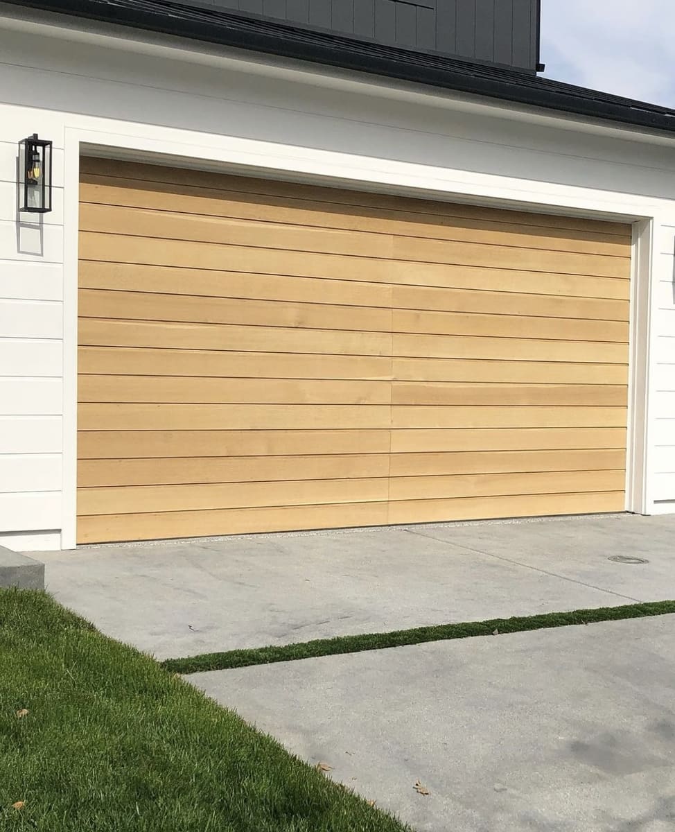 Custom wood garage door with architectural detailing